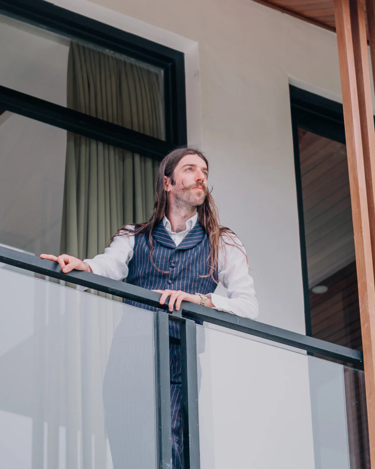 Stewart Vickers on a balcony in a pinstripe waistcoat and white shirt