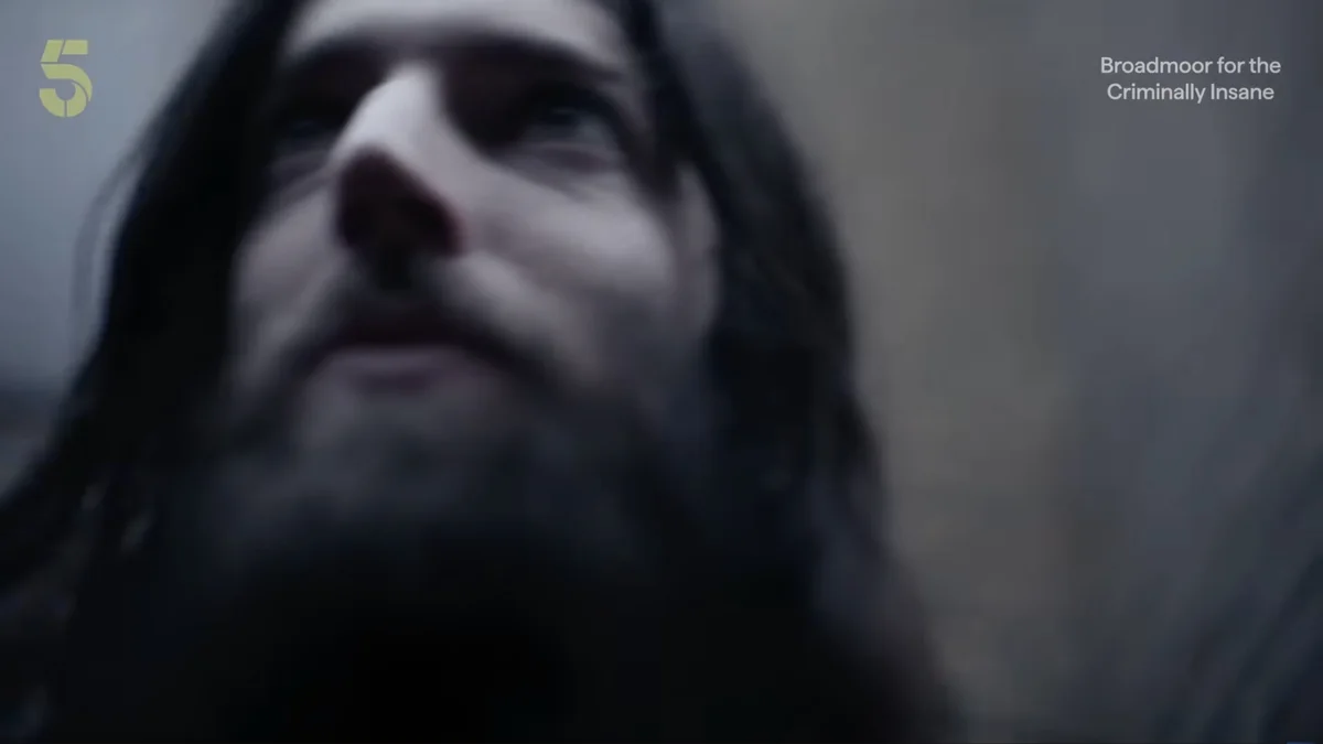 Frame from Broadmoor: For the Criminally Insane, a long-bearded figure shot from below in the John Silver reconstruction